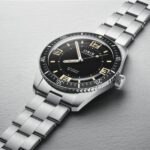 Stylish stainless steel wristwatch with black dial and elegant sporty design.