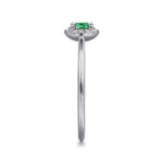 Elegant emerald-cut emerald ring with diamond halo in white gold, perfect for special occasions.