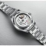 Elegant stainless steel watch showcasing intricate movement and craftsmanship through a transparent case back.