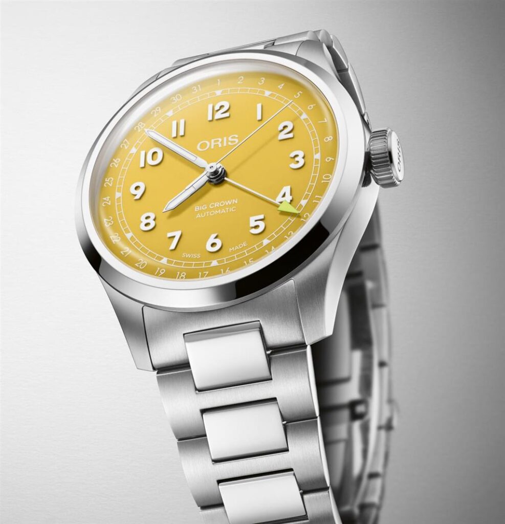 Oris watch features a vibrant yellow dial, oversized numerals, and stainless-steel bracelet for style.