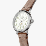 Elegant Shinola watch with silver stainless steel case and brown leather strap, perfect for any occasion.