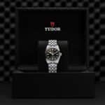 Luxurious Tudor watch elegantly presented in premium black packaging with exquisite detailing.