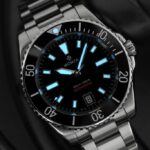 Sophisticated divers watch with luminous dial, stainless steel case, and unidirectional bezel.