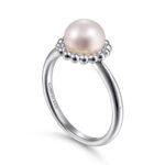 Elegant silver ring with a pearl and halo, perfect for any occasion.