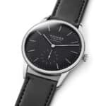 Elegant Nomos Glashütte watch featuring a black dial, stainless steel case, and luxury leather strap.