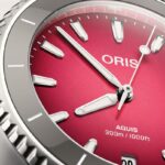 Stylish Oris Aquis diving watch with bold red dial and stainless steel case.