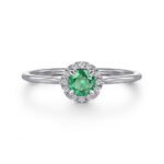 Stunning green gemstone halo ring with diamonds in elegant white gold setting.