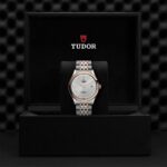 Luxurious Tudor watch in stainless steel and rose gold, elegantly presented in an opulent box.