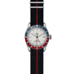 Tudor GMT watch in stainless steel with bi-color bezel and black textile strap.
