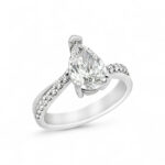 Elegant pear-shaped diamond engagement ring with pave accents in a lustrous white metal band.