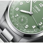 Elegant Oris Big Crown watch with green dial, Arabic numerals, and Swiss craftsmanship.