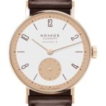Sophisticated NOMOS Glashütte neomatik wristwatch in rose gold with minimalist design and brown leather strap.
