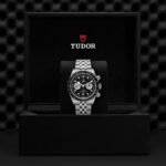 Elegant Tudor watch in a luxurious box, showcasing a sporty yet sophisticated design.