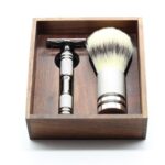 Elegant grooming set in a wooden box featuring a safety razor and shaving brush.