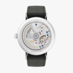 Sleek wristwatch showcasing intricate mechanical movement and luxurious craftsmanship in a polished silver case.