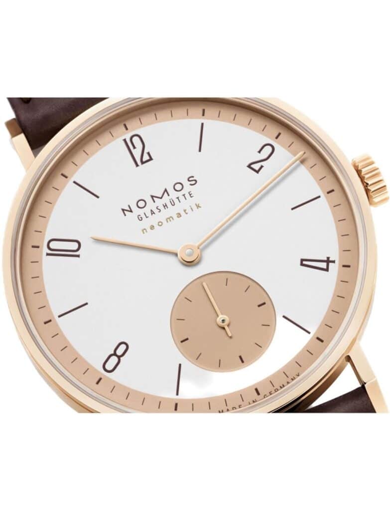 Elegant NOMOS Glashütte rose gold watch with minimalist design and classic leather strap.