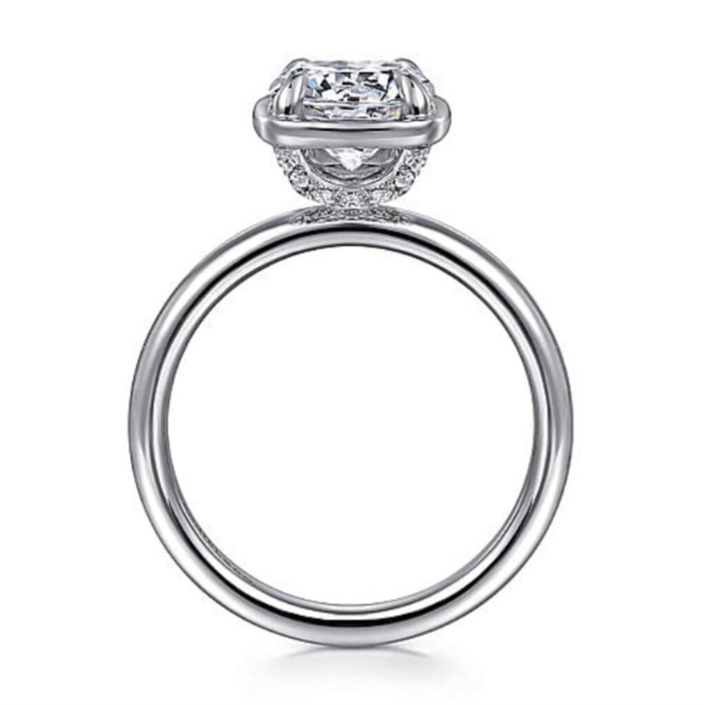 Elegant engagement ring with a sparkling diamond and intricate setting in platinum or white gold.