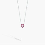 Elegant heart-shaped necklace with vibrant pink stones on a silver chain. Perfect for romantic occasions.