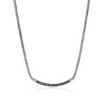 Elegant silver necklace with bold pendant and black gemstone accents for modern sophistication.