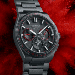 Sleek Seiko Astron watch with black finish, red accents, advanced features, and stainless steel bracelet.