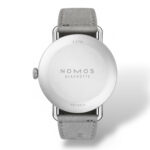 Stylish NOMOS Glashütte Metro 5 wristwatch with minimalist design and gray leather strap.