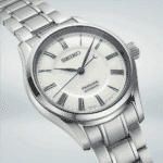 Elegant Seiko Presage automatic watch featuring a stylish silver case, creamy dial, and blue hands.