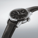 Elegant Seiko automatic wristwatch with black dial, stainless steel case, and leather strap.
