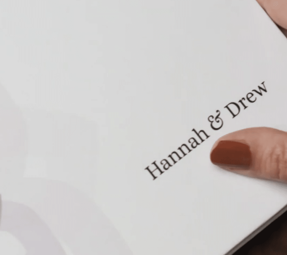 Elegant booklet cover featuring Hannah & Drew in sophisticated typography on a white background.