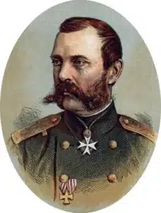 Portrait of a distinguished military officer in ornate uniform with medals and serious expression.