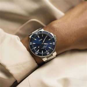 Stylish wristwatch with blue face and stainless steel bracelet, perfect for any occasion.