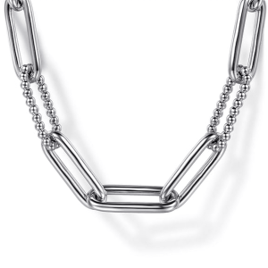 Modern silver necklace with interlinked rectangular links and spherical beads for stylish accessorizing.