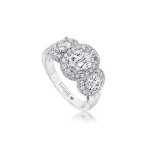 Elegant three-stone diamond ring in white gold with halo settings, perfect for engagements or anniversaries.