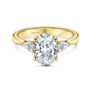 Elegant engagement ring with oval diamond and pear-shaped accents in polished yellow gold.