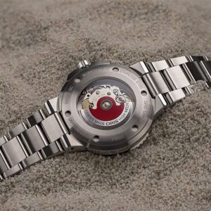 Swiss-made wristwatch with intricate mechanics displayed on a sandy background for a rugged look.