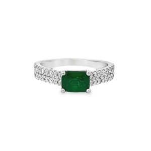 Elegant emerald-cut green gemstone ring with sparkling diamonds in white metal setting.
