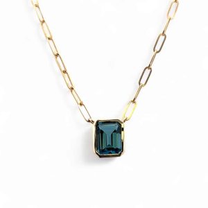 Elegant gold necklace featuring a stunning teal emerald gemstone pendant for sophisticated style.