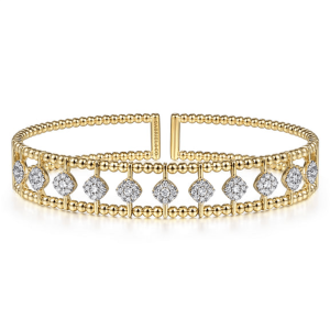 Elegant gold cuff bracelet with sparkling cubic zirconia, perfect for any occasion.