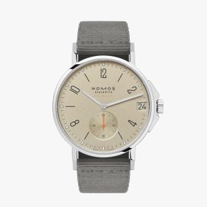 Elegant NOMOS Glashütte watch with beige dial, stainless steel case, and gray textile strap.