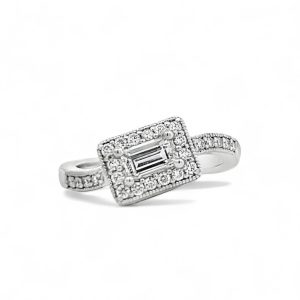 Elegant emerald-cut diamond ring with halo of smaller diamonds in white gold.