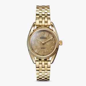 Elegant Shinola gold watch with sophisticated design, polished case, and stylish bracelet.