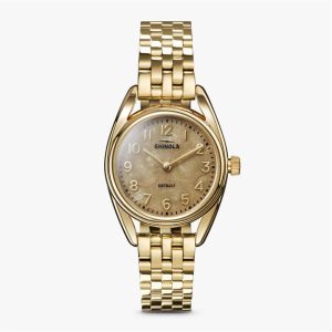 Elegant Shinola gold watch with sophisticated design, polished case, and stylish bracelet.