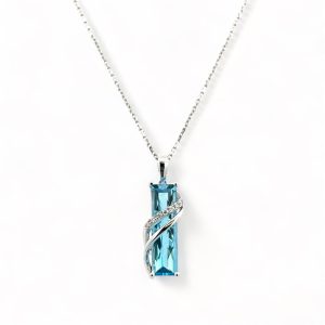 Elegant blue gemstone pendant necklace in silver setting, perfect for any occasion.