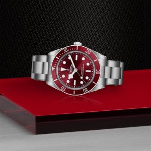 Tudor dive watch with burgundy dial, stainless steel case, and durable bracelet for adventurers.