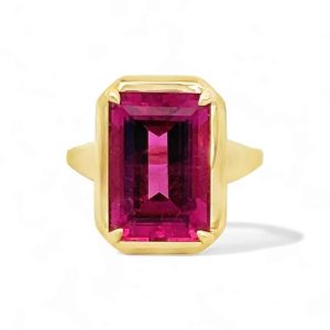 Elegant yellow gold ring featuring a vivid pink emerald-cut gemstone for statement jewelry.