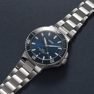 Oris diving watch with sleek blue dial, stainless steel bracelet, and rotating bezel for functionality.