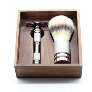 Elegant grooming set in a wooden box featuring a safety razor and shaving brush.