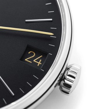 Elegant black watch face with gold and silver accents, featuring intricate craftsmanship and date display.