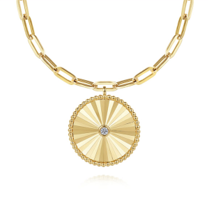 Elegant gold necklace with intricate sunburst pendant and sparkling gemstone centerpiece.