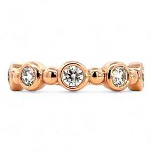 Elegant rose gold ring with sparkling stones, perfect for engagement or everyday wear.
