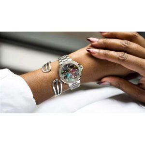 Stylish womans wrist with a silver watch and elegant bracelet in a close-up view.